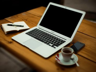 MacBook Air on brown wooden table