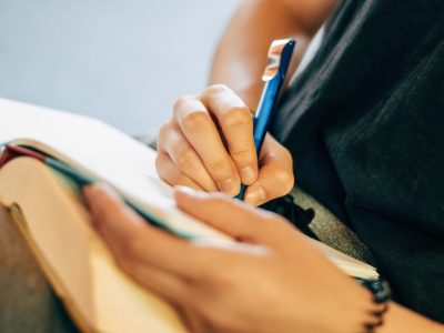 shallow focus photo of person writing