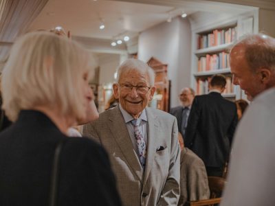 smiling man wearing suit standing beside man